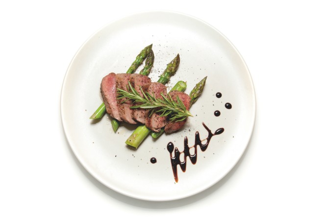 Filet of Lamb sliced on a bed of Asparagus with Balsamic Vinegar decoration