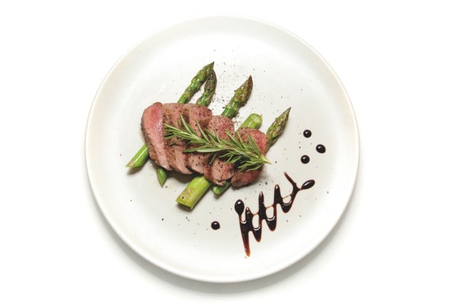 Filet of Lamb sliced on a bed of Asparagus with Balsamic Vinegar decoration