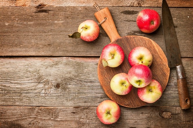 Fresh organic ripe apples on rustic wooden table, top view with copy space