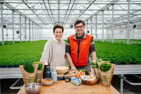 Tici steht an einem Tisch im Kräutergarten vor verschiedenen Zutaten 