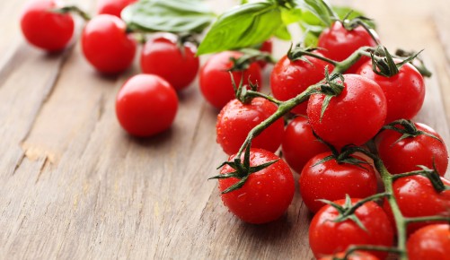 Fresh cherry tomatoes on old wooden table
