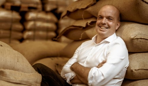 Bernhard Prosser von Fred Kaffee vor vielen Kaffeesäcken